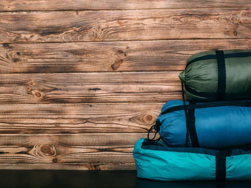 different types of sleeping bags on a table