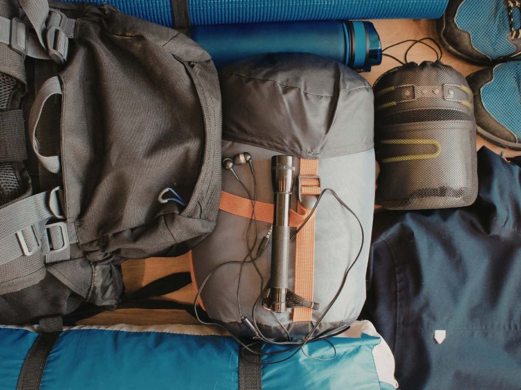 Camping gear laid out for packing, showing common camping mistakes like overpacking or poor organisation.